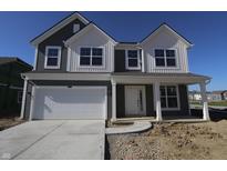 Two-story home with a white two-car garage, covered porch, gray siding and manicured lawn at 10138 Redwood Peak Ln, Indianapolis, IN 46259