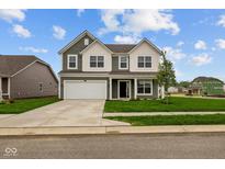 Charming two-story home featuring a well-manicured lawn and a two-car garage on a sunny day at 10138 Redwood Peak Ln, Indianapolis, IN 46259