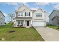 Charming two-story home with a well-manicured lawn, brick accents, and attached two car garage at 10810 Arendale Dr, Brownsburg, IN 46112