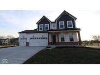 Charming two-story home with a three-car garage and inviting front porch at 1114 Ridgevine Rd, Greenwood, IN 46143