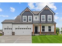 Striking two-story home with a three car garage, craftsman details and a well-manicured lawn at 1114 Ridgevine Rd, Greenwood, IN 46143