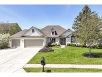 Charming single Gathering home with a well-manicured lawn and three-car garage, perfect for curb appeal at 11862 Stoney Bay Cir, Carmel, IN 46033