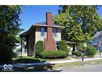 Charming two-story home with blue trim, large front yard and inviting front porch at 1396 Logan St, Noblesville, IN 46060