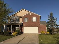 Charming two-story brick home featuring an attached two-car garage and well-maintained front yard at 1539 Egret Ln, Greenwood, IN 46143