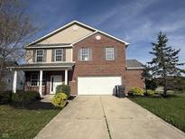 Charming two-story brick home with a well-manicured lawn and attached two-car garage at 1539 Egret Ln, Greenwood, IN 46143