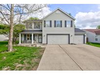 Charming two-story home features a two car garage, gray siding, and a covered front porch at 18980 Bladed Mills Dr, Noblesville, IN 46062
