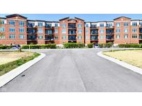Attractive brick building with multiple stories and balconies on a sunny day at 20971 Shoreline Ct # 305, Noblesville, IN 46062