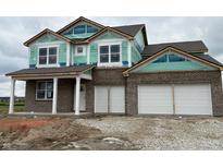 Under construction two-story brick home featuring an attached two car garage and covered porch at 210 Aster Way, Greenfield, IN 46140