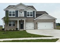 Charming two-story home featuring a two-car garage, manicured lawn, and a blend of brick and siding accents at 210 Aster Way, Greenfield, IN 46140