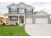 Charming two-story home with a manicured lawn, a two-car garage, and attractive brick and vinyl siding at 210 Aster Way, Greenfield, IN 46140