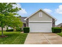 Charming single-Gathering home with well-manicured lawn and two-car garage and partial brick facade at 2138 Rossington Ln, Indianapolis, IN 46229