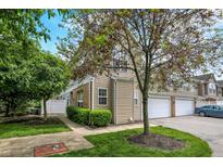 Charming townhome featuring vinyl siding, attached garage, and well-maintained landscaping at 2270 Brightwell Pl, Indianapolis, IN 46260