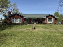 Charming one-story brick home with a well-manicured front yard and blue trim at 244 E Cragmont Dr, Indianapolis, IN 46227