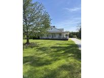 Charming home featuring a welcoming porch and well-maintained lawn with a large shade tree at 3333 S Sr 9, Greenfield, IN 46140