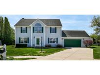 Charming two-story home with green garage door, manicured lawn, and beautiful landscaping at 4243 Bay Leaf Cir, Indianapolis, IN 46237