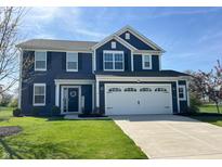 Two-story home with a two-car garage, dark siding, white trim, and a well-manicured lawn at 4245 W Fork Dr, Westfield, IN 46062