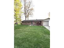 Charming brick ranch home with a well-manicured lawn and attached garage at 6226 Fairlane Dr, Indianapolis, IN 46259