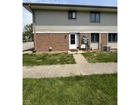 Inviting front entrance featuring a brick facade and well-maintained lawn at 6458 Lupine Ter, Indianapolis, IN 46224