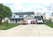 Charming two-story home featuring a brick-accented facade, attached garage, and well-manicured lawn at 7121 Fields Way, Indianapolis, IN 46239