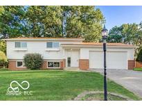 Charming single-Gathering home with manicured lawn and mature trees adding curb appeal at 7206 Halden Pl, Indianapolis, IN 46214