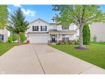 Inviting two-story home boasts a well-maintained lawn and attached two-car garage at 825 Palisades Ct, Greenwood, IN 46143