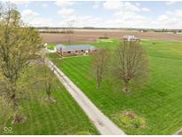 Sprawling single story brick home on expansive green lawn in a rural setting at 10239 Wilson Rd, Brownsburg, IN 46112