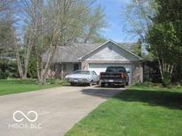 Charming one-story home with attached garage and inviting front yard at 1080 W Wildflower Ct, Mooresville, IN 46158
