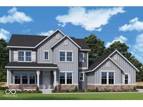 Charming two-story home featuring gray siding, dark roof, manicured lawn, and stylish architectural details at 11338 Briargate Dr, Fishers, IN 46055