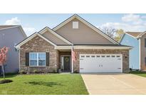 Charming single Gathering home with a brick facade, attached garage, and a well manicured front lawn at 122 Winding Brook Way, Pendleton, IN 46064