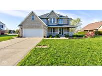 Charming two-story home with a well-manicured front lawn and attached two-car garage at 2215 Golfside Dr, Lebanon, IN 46052