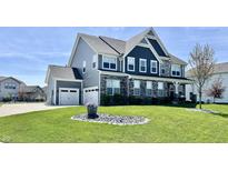 Beautiful two story home with manicured lawn, gray siding and stone facade with a two car garage at 4205 Hunt Club Pkwy, Bargersville, IN 46106