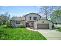 Charming two-story home featuring a well-manicured lawn, a brick and siding exterior, and an attached two-car garage at 4977 Beechwood Rd, Avon, IN 46123