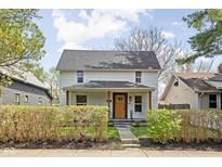 Charming two-story home featuring a cozy front porch and well-maintained landscaping at 611 Tecumseh St, Indianapolis, IN 46201