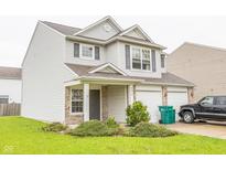 Two-story home featuring neutral siding, brick accents, attached two-car garage and well-maintained lawn at 6376 Matcumbe Way, Plainfield, IN 46168