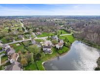 Scenic aerial shot of a neighborhood featuring well-maintained homes and a tranquil pond at 6514 Trevia Ct, Indianapolis, IN 46236