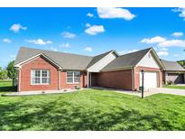 Charming red brick home with a well-maintained lawn and inviting curb appeal at 7618 Ballyshannon St, Indianapolis, IN 46217