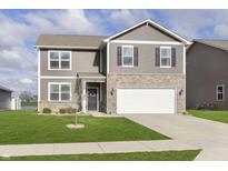 Charming two-story home with gray siding, stone accents, well-manicured lawn, and an attached two-car garage at 813 Sonoma Ln, Greenfield, IN 46140
