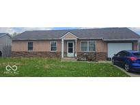 Charming single-story home with an attached garage and freshly cut lawn in a quiet neighborhood at 1370 Ash Ct, Martinsville, IN 46151