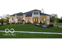 Beautiful single-Gathering home with manicured lawn, lush landscaping, and a stately exterior at 13855 Waterway Blvd, Fishers, IN 46040