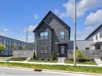 Modern two-story home featuring sleek dark siding and well-manicured landscaping at 1702 Alvord St, Indianapolis, IN 46202