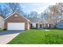 Charming brick home features a manicured lawn, two-car garage, and inviting entryway perfect for suburban living at 17027 Rainier Cir, Westfield, IN 46062