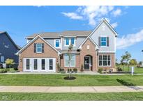 Stunning new construction home featuring brick accents, a manicured lawn and a charming covered entry way at 19472 Lewis Cir, Westfield, IN 46074
