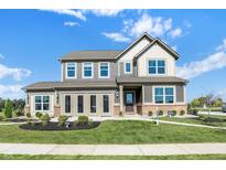 Two-story home with brick and siding details, manicured lawn, and inviting front entrance at 19492 Lewis Cir, Westfield, IN 46074