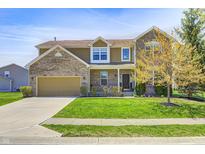 Inviting two-story home with brick accents, attached garage, and well-manicured front lawn and mature tree at 3147 Winings Ln, Carmel, IN 46074