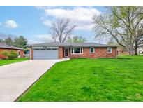 Charming brick ranch home with an attached garage and beautiful front lawn at 4464 Chatham Dr, Brownsburg, IN 46112
