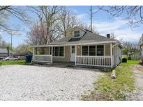 Charming single-story home featuring a cozy front porch and a gravel driveway at 5209 Melrose Ave, Indianapolis, IN 46241