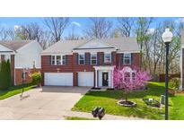 Charming two-story brick home with a well-manicured lawn and a two car garage at 5924 Skyward Ln, Indianapolis, IN 46234