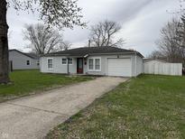 Charming single-story home with a one-car garage and a well-maintained lawn at 823 N Noble St, Greenfield, IN 46140