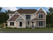 Two-story home showcasing stone and brown shingle accents, complemented by white siding and professional landscaping at 967 Apryl Dr, Greenwood, IN 46143