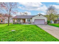 Charming ranch home featuring a well-manicured lawn, covered porch, and attached two car garage at 990 Bull Run W Dr, Greenwood, IN 46143